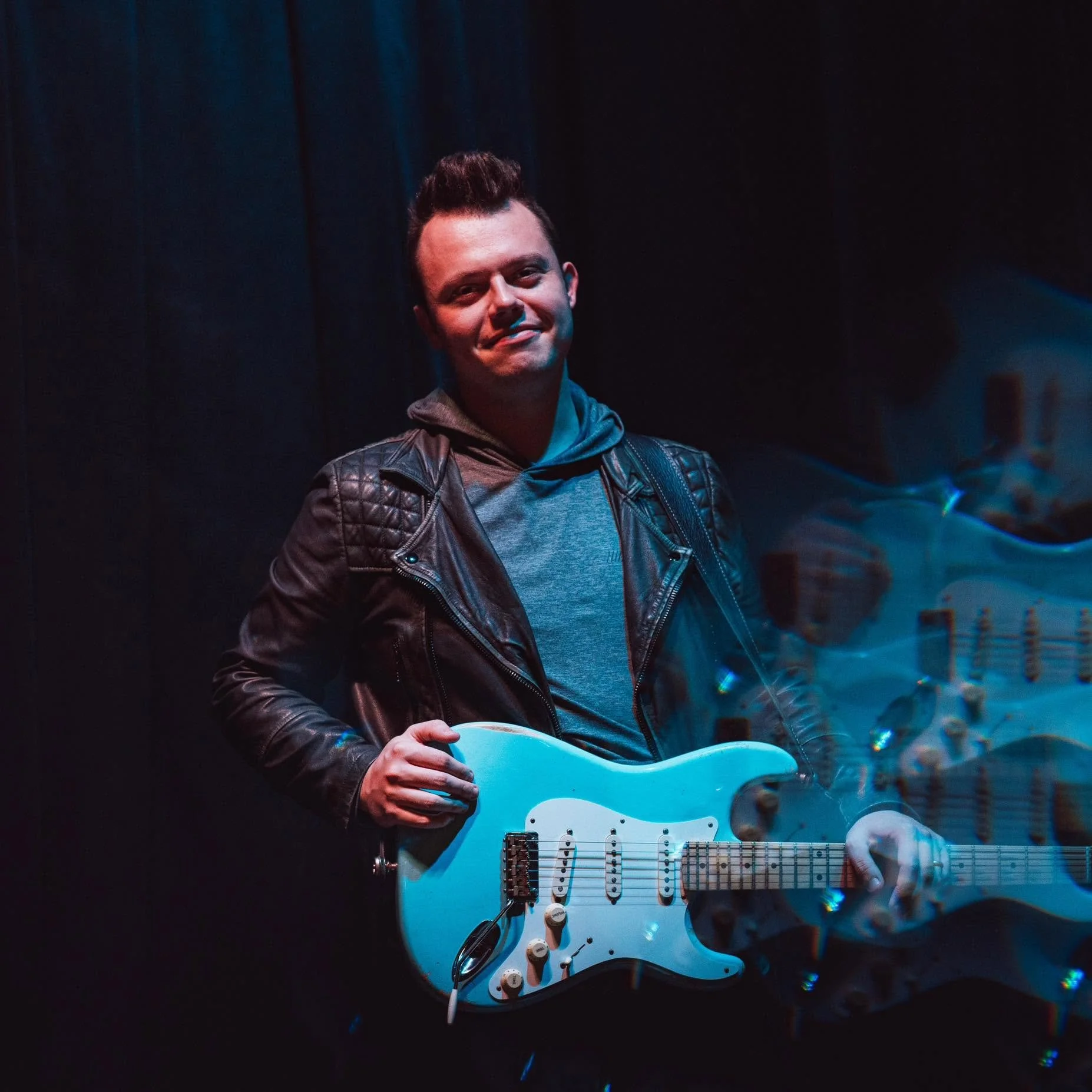 Christian artist performing live on electric guitar