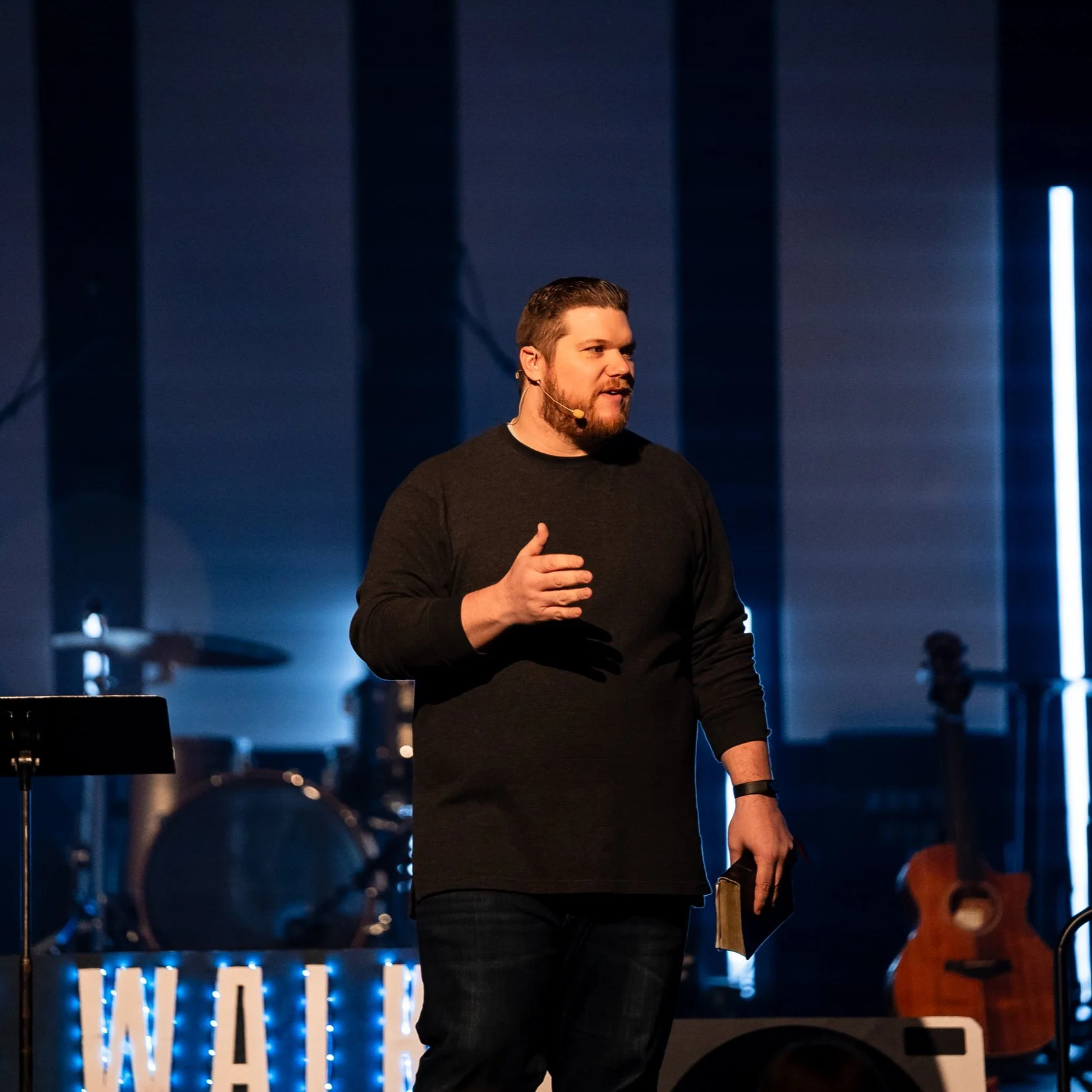 Christian speaker Brett Brandewie speaking on stage at a church or ministry event.