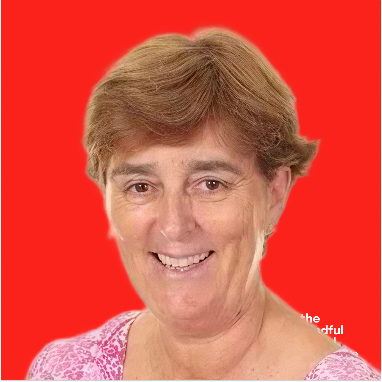 A smiling middle-aged woman with short, light brown hair set against a bright red background.
