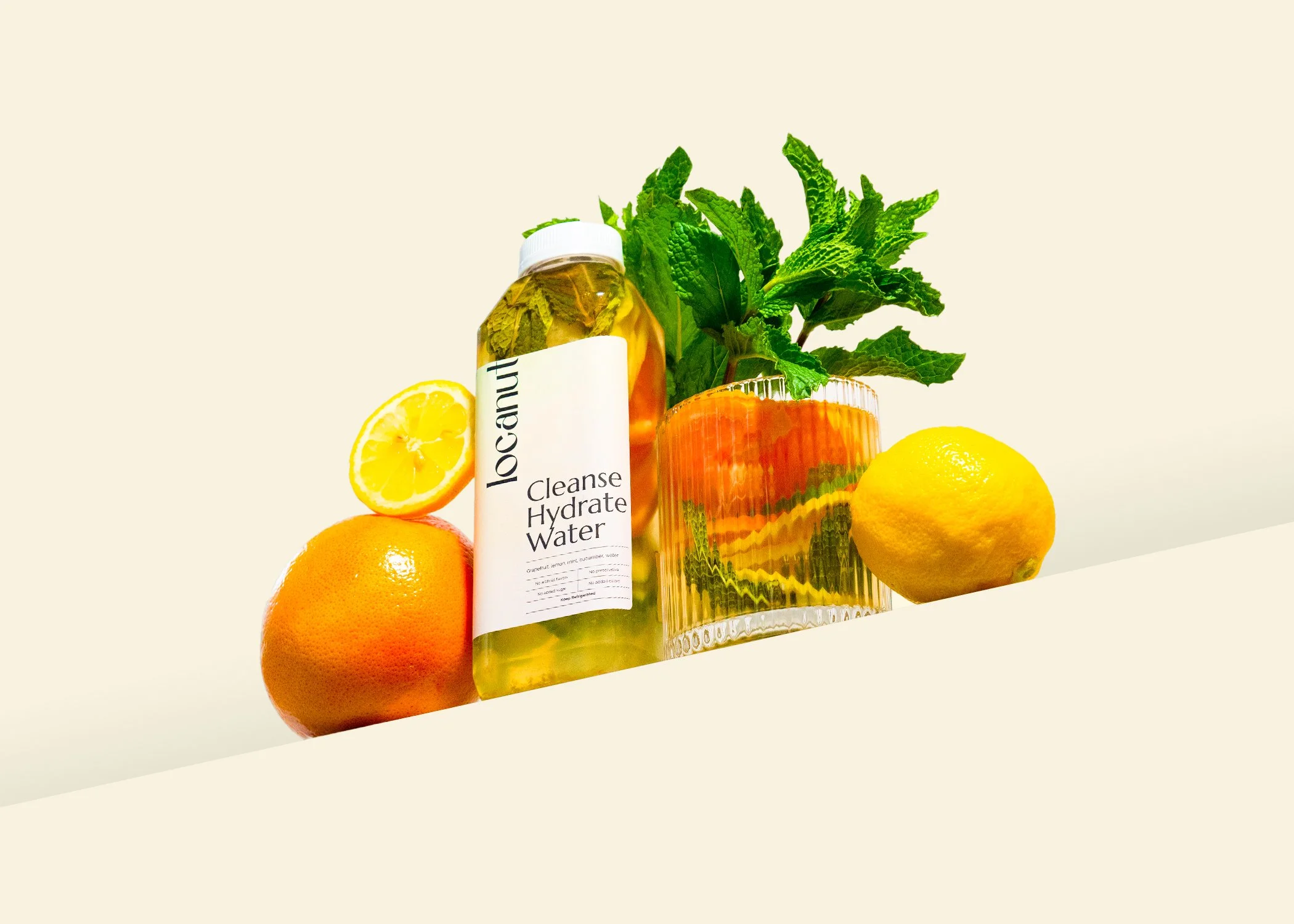 Bottle of cleanse hydrate water with lemons, grapefruit, and mint leaves