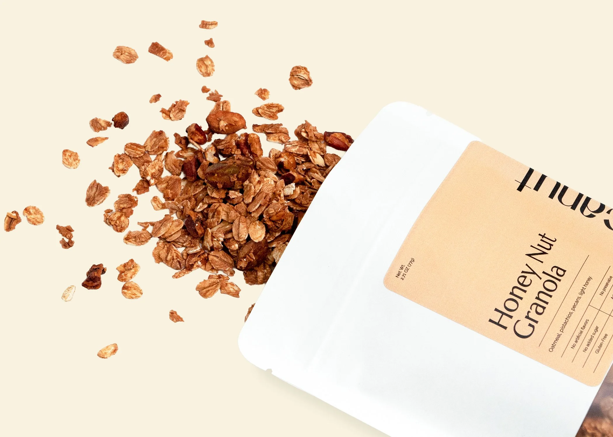 Bag of honey nut granola spilling out onto a surface.