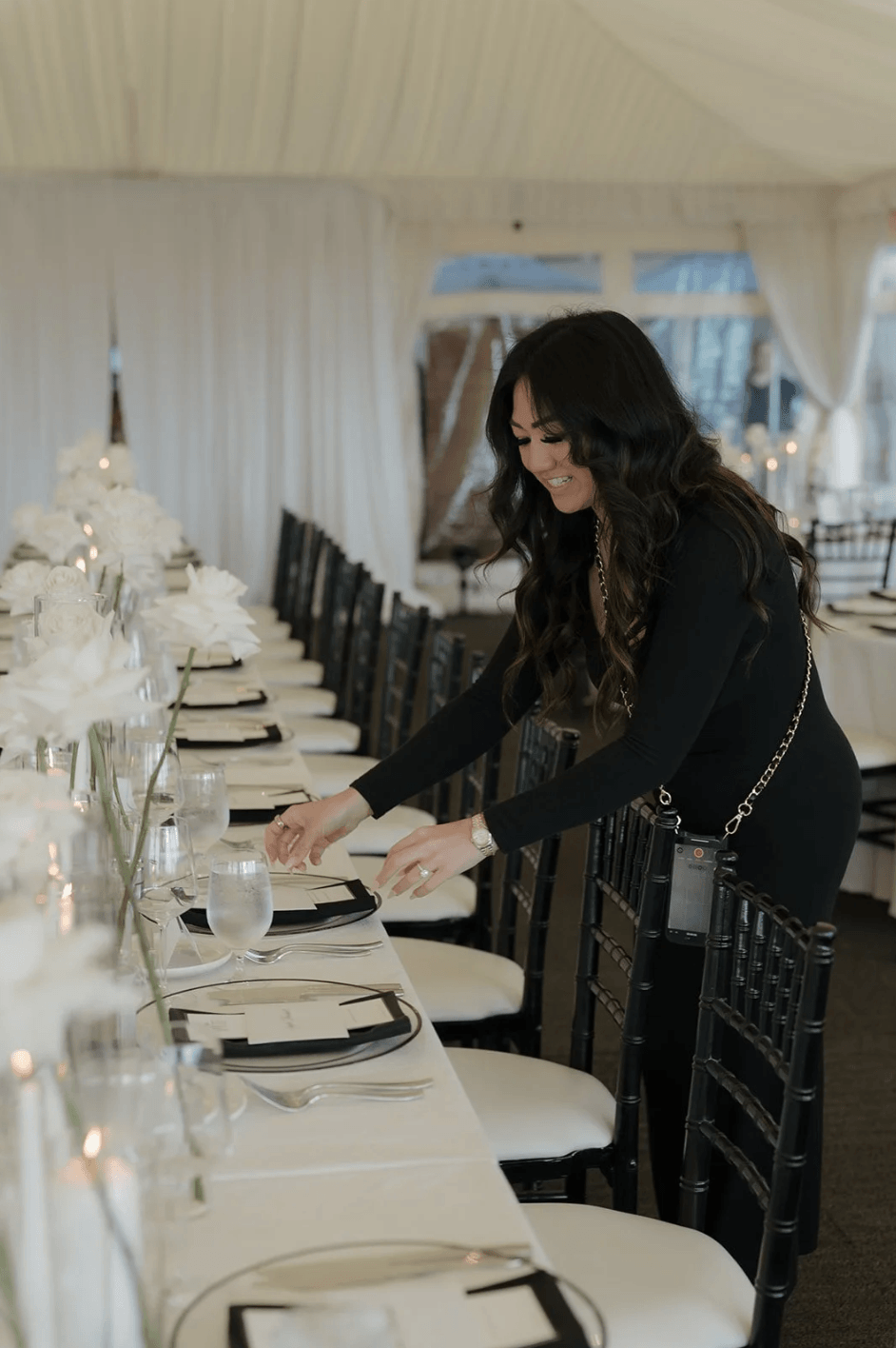 Gian Events planner setting a wedding reception table, showcasing behind-the-scenes event production and design details