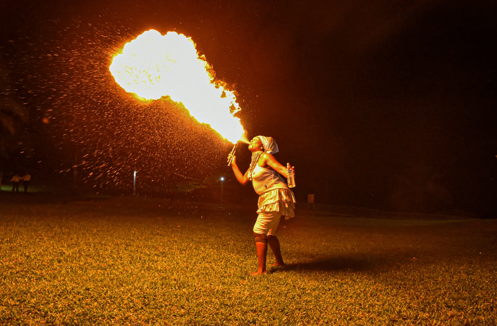 Fire performer breathing flames during an outdoor luxury event entertainment experience