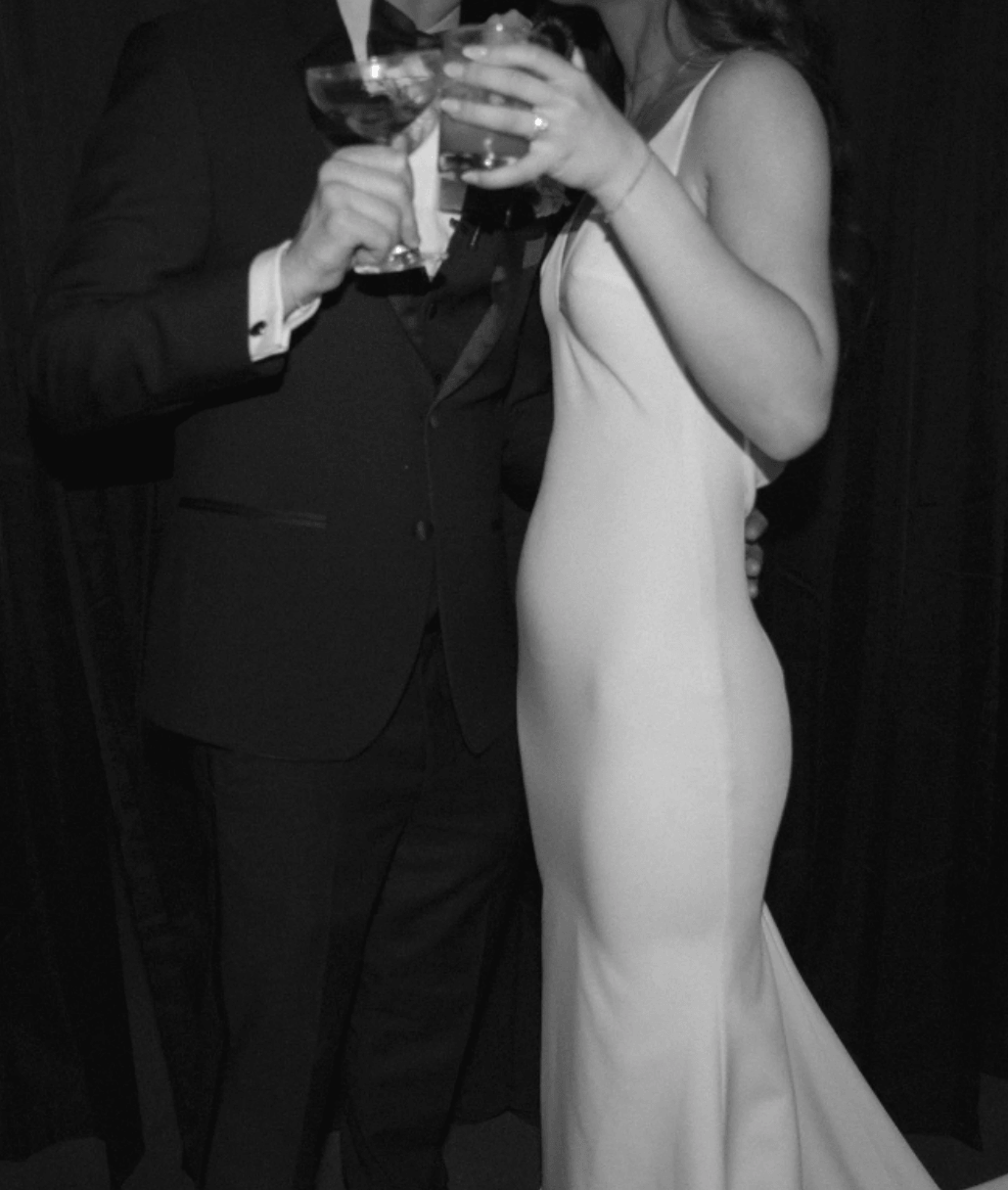 Editorial wedding couple toasting at a black-tie reception, capturing a candid luxury event moment by Gian Events