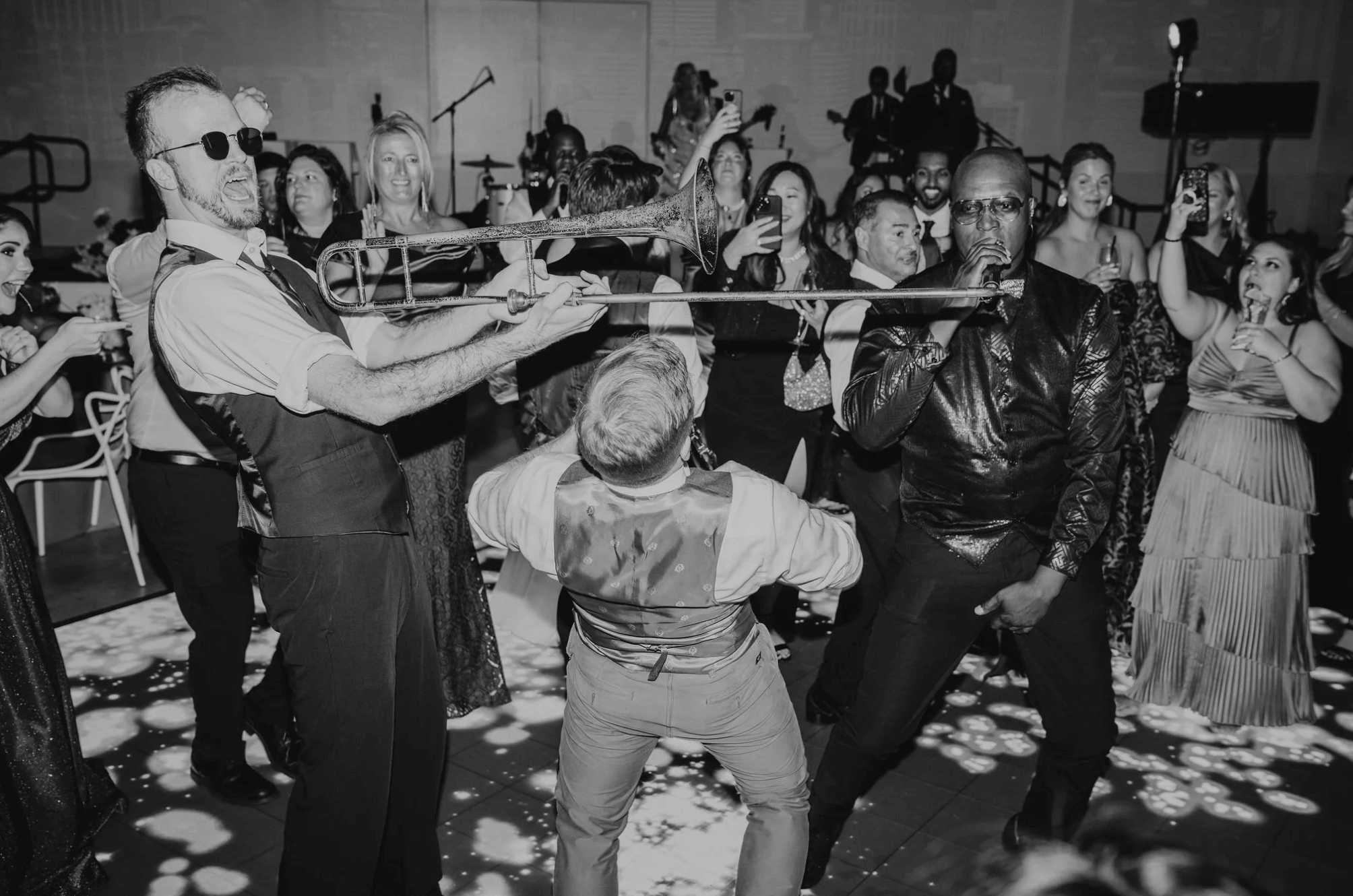 Live band performing on a crowded dance floor during a high-energy wedding reception