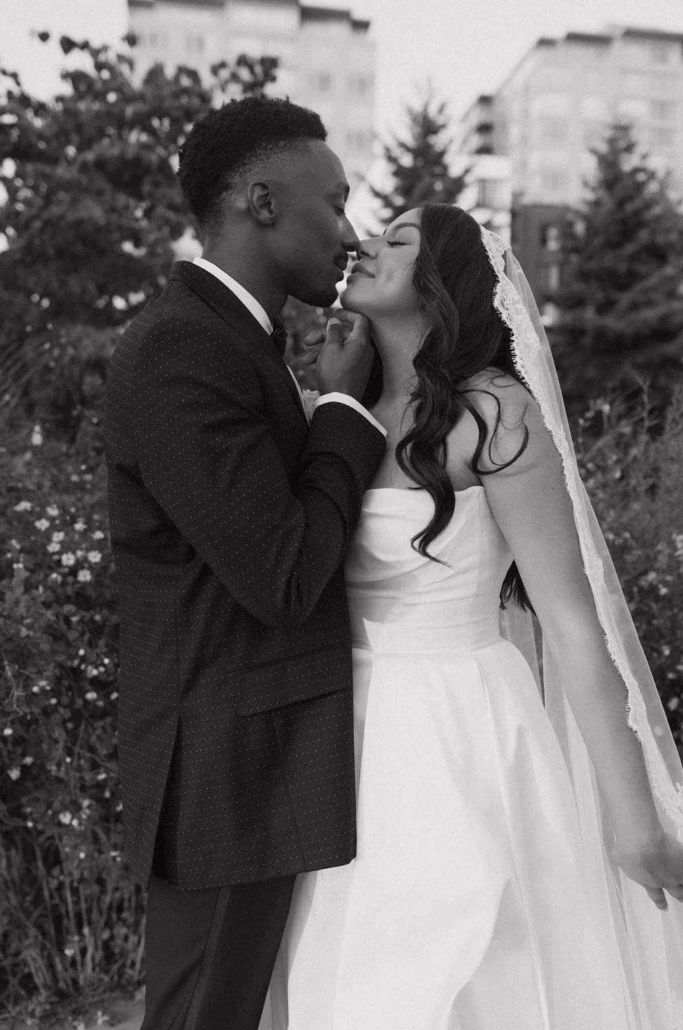Romantic editorial wedding portrait of a couple kissing outdoors, styled and produced by Gian Events