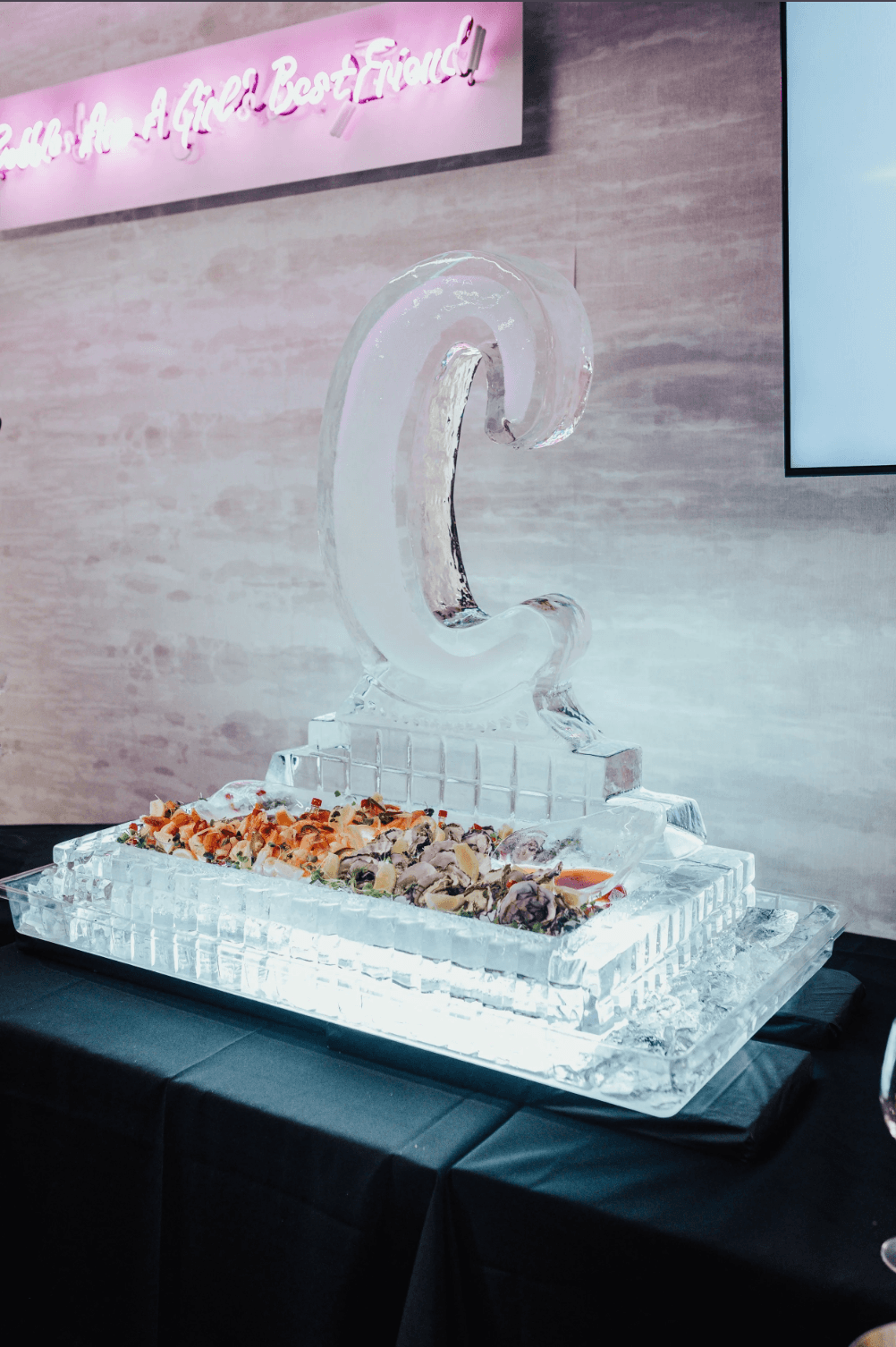 Upscale event catering display with carved ice sculpture and fresh seafood presentation by Gian Events