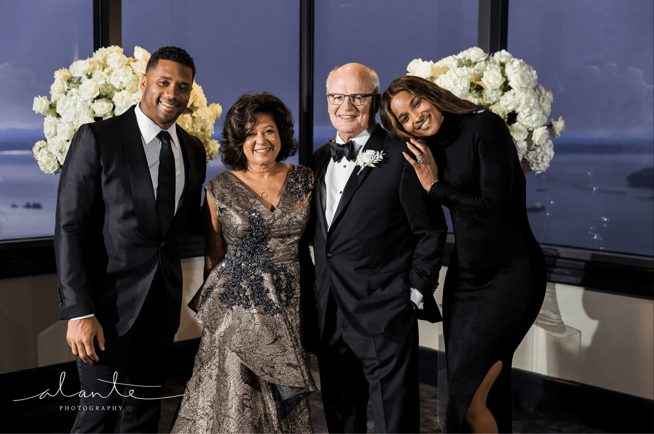 Guests posing at a luxury formal event with elegant attire and floral backdrop designed by Gian Events