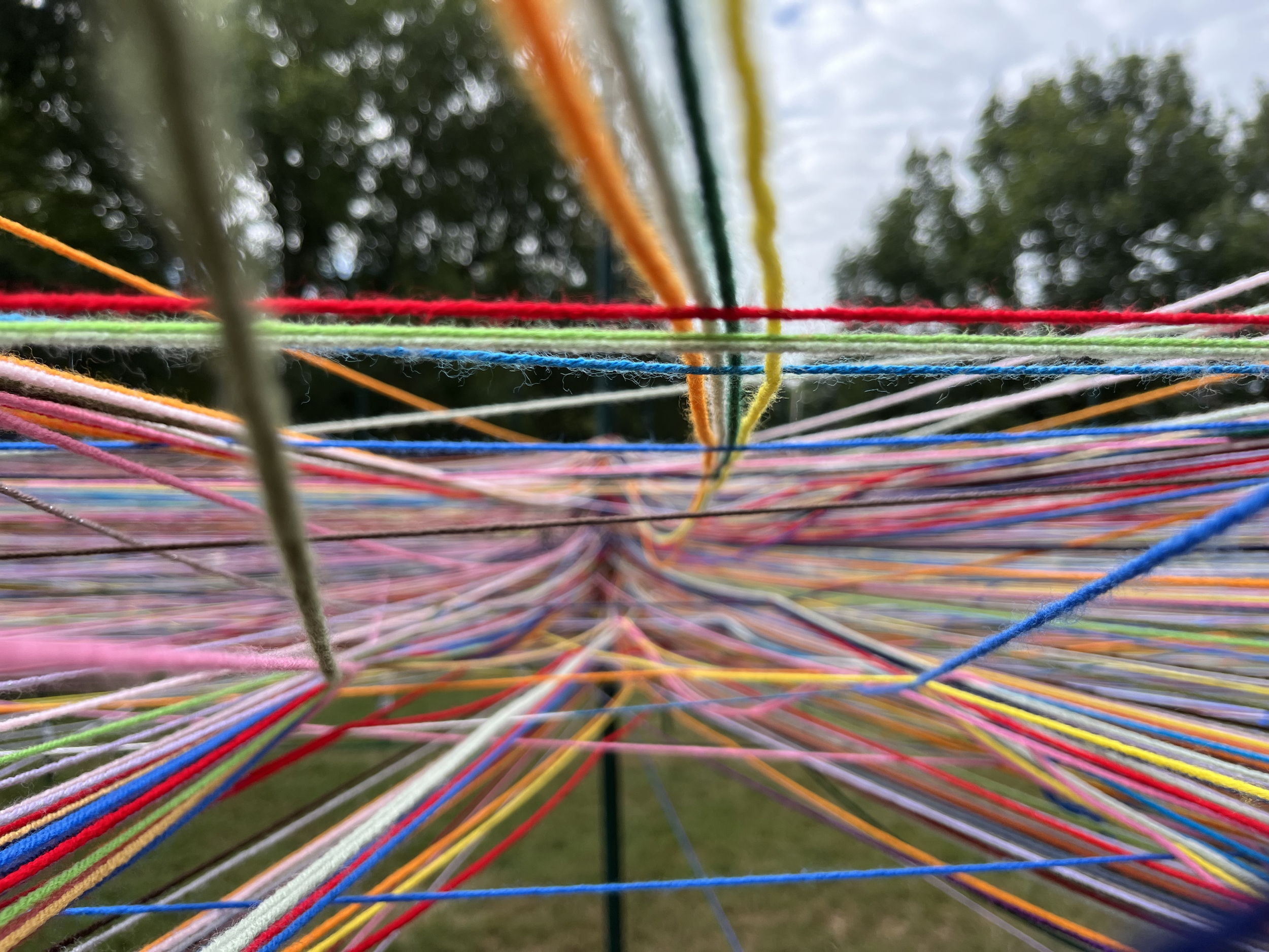 multi-colors of yard intertwined and tied to a pole