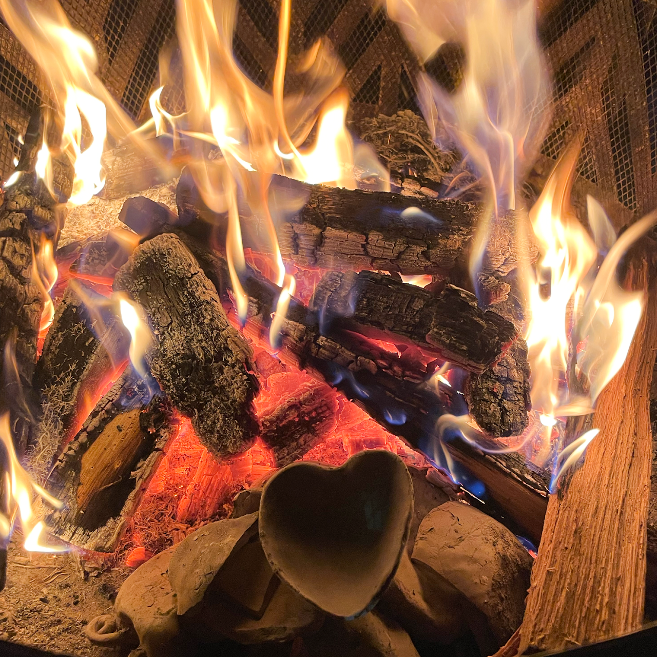 a bonfire with ceramic pinch pots