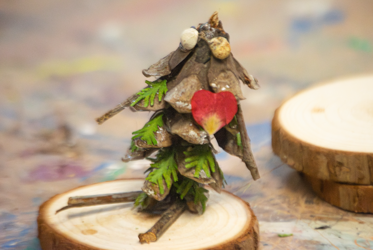 a piece of art that was made using items from nature such as tree branches, bark, and leaves.