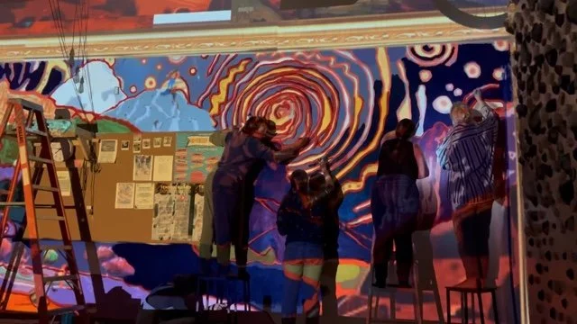 people creating a colorful mural