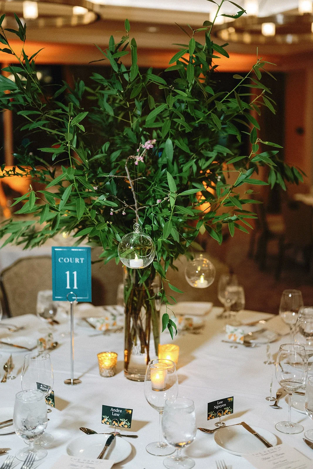 Lush green wedding centerpiece with hanging globes