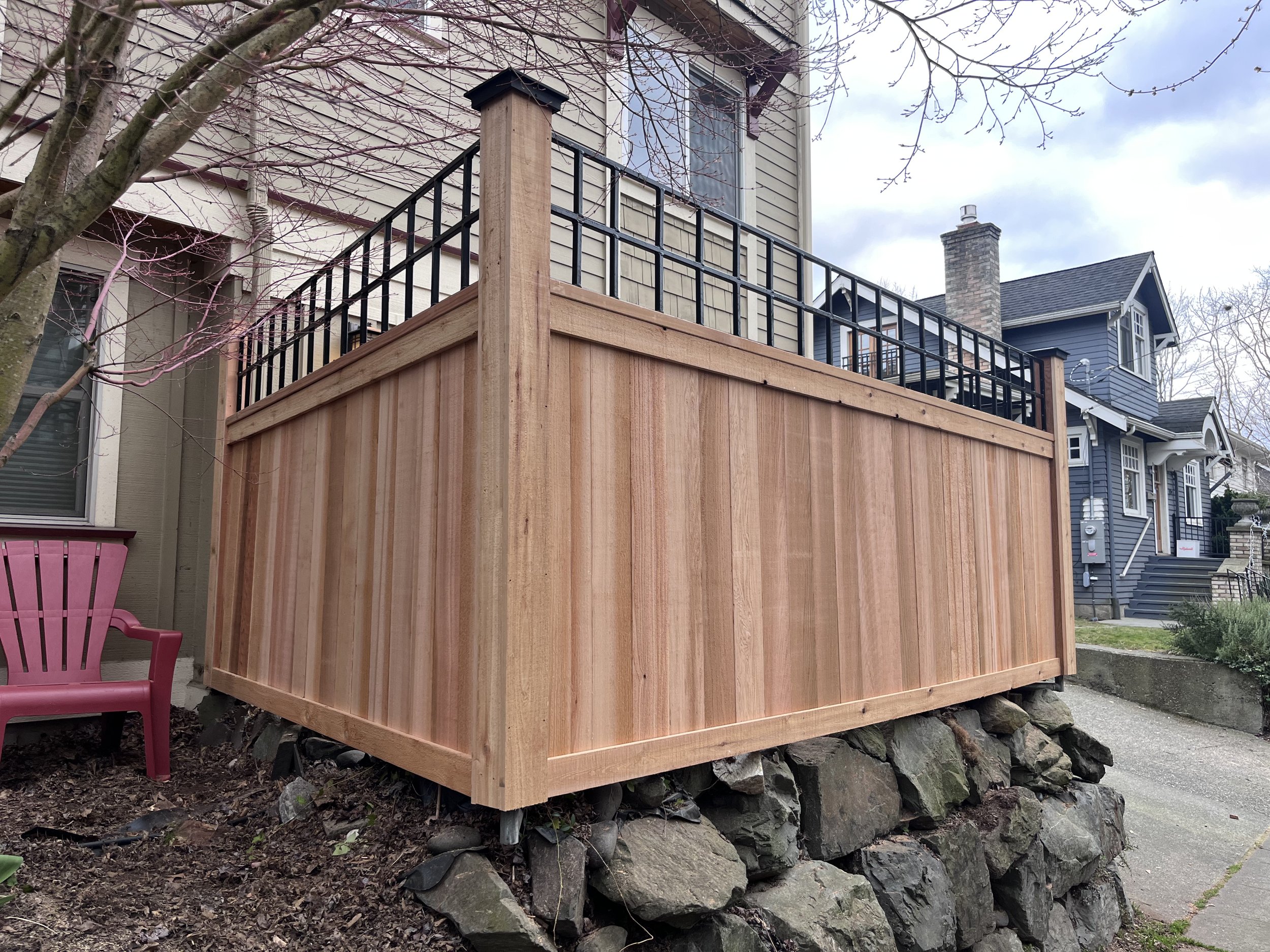 Clear Cedar Fence with Cedar Wrapped Posts and Metal Trellis in Queen Anne