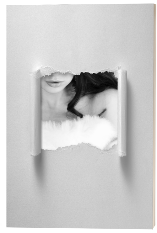 A woman looking through a torn paper hole in a white wall, with the picture of a woman with dark hair and a furry white garment visible through the hole.