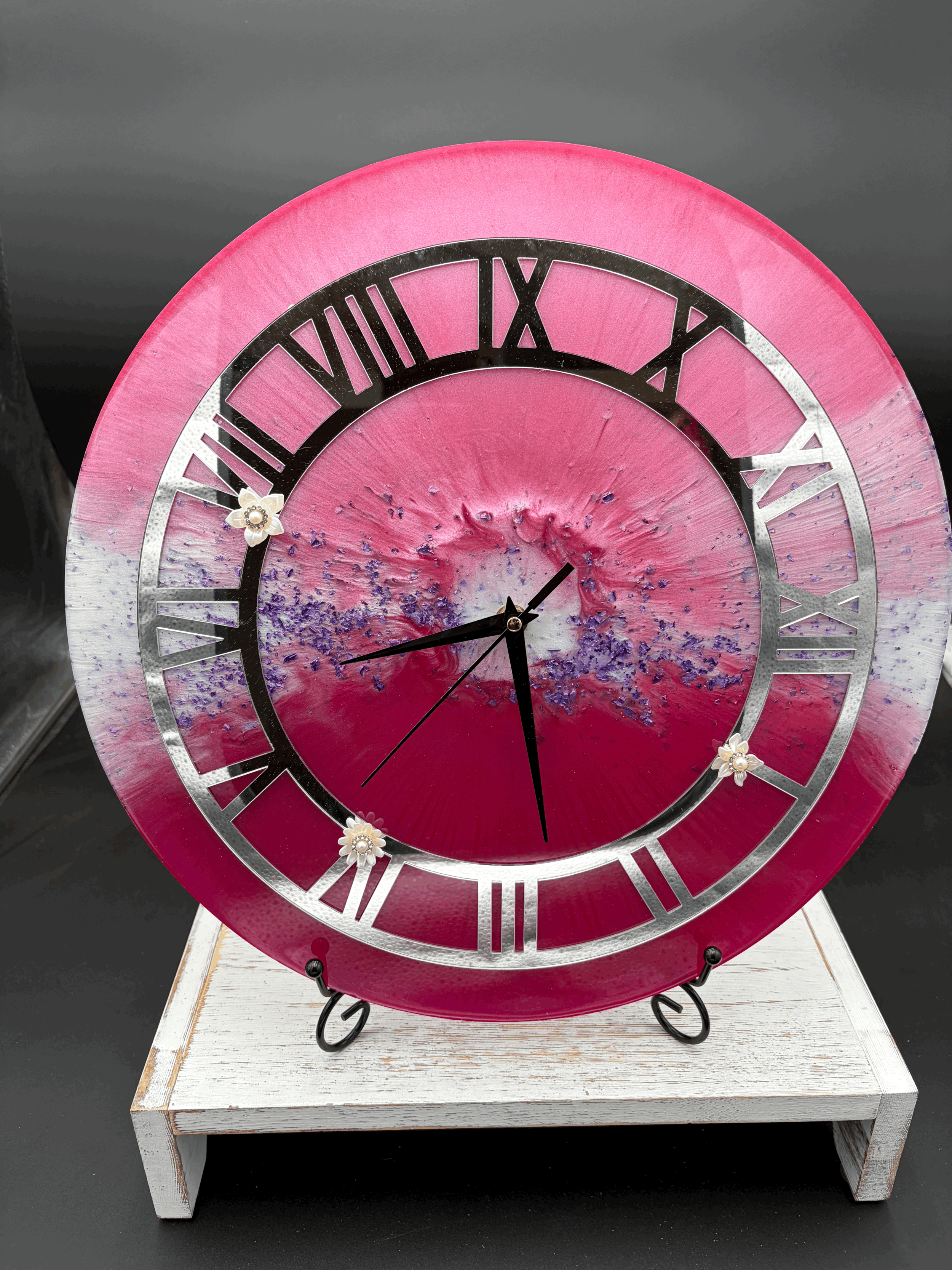 Pink clock with silver face and white flowers
