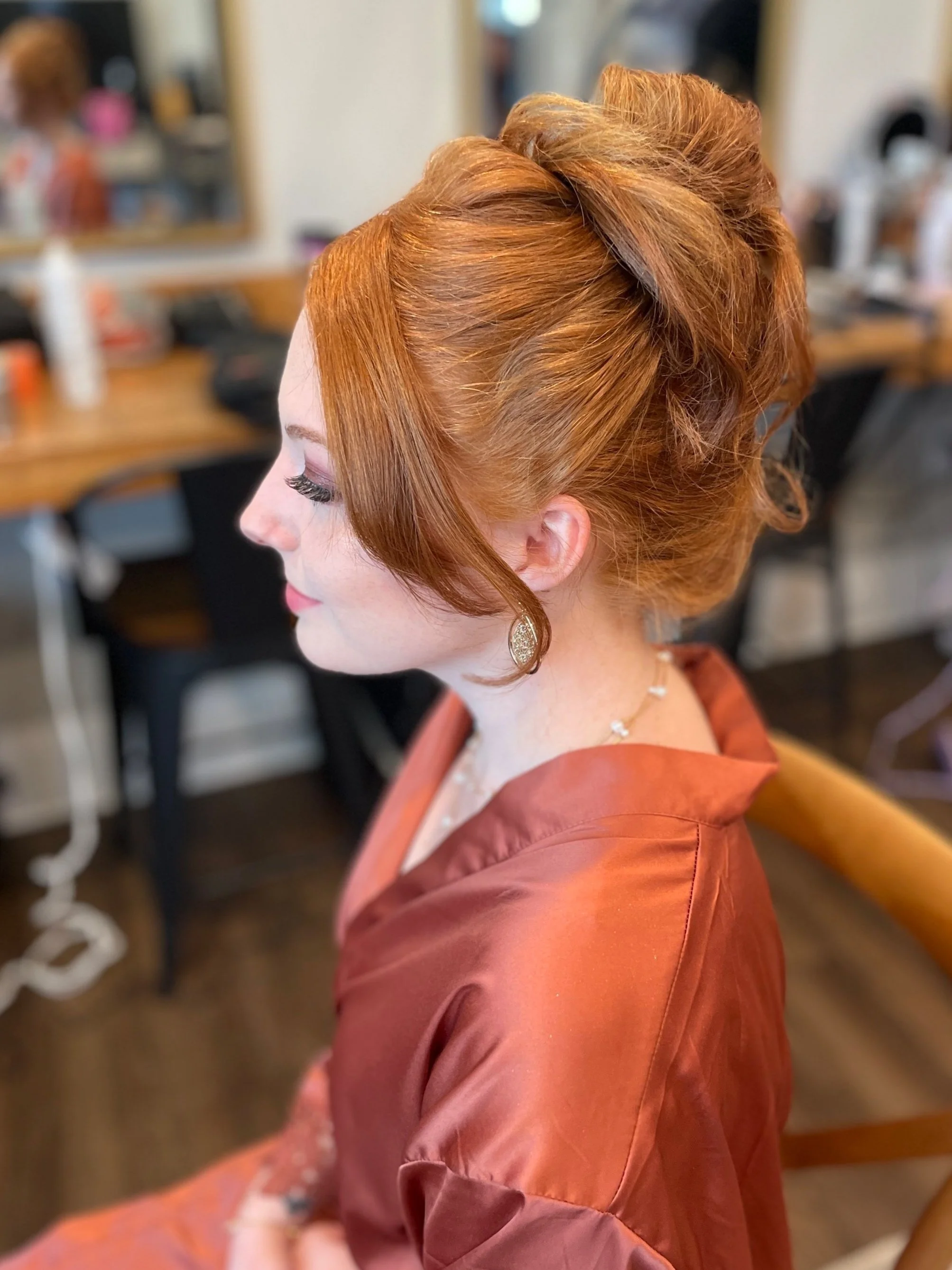 Natural bridal hair styled in high bun with delicate face-framing curls for Maryland wedding
