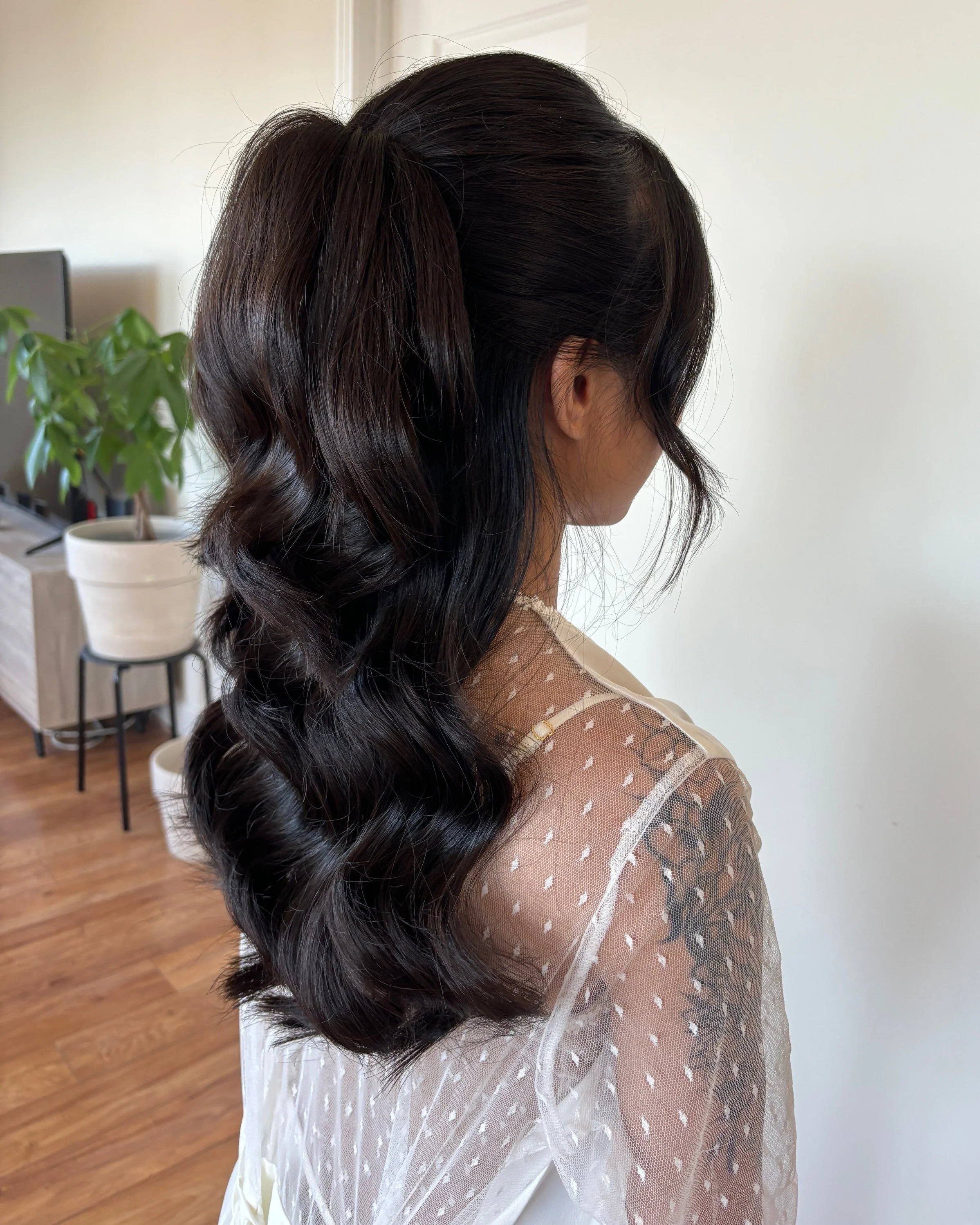 Dark brown wavy bridal hair pulled into elegant high ponytail in Maryland