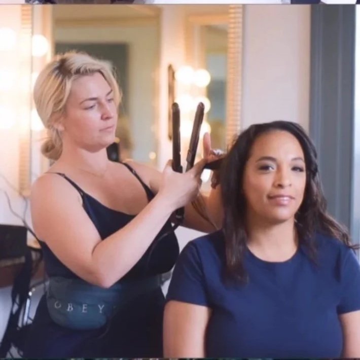 Behind the scenes of Maryland bride getting wedding hair styled, updo adjusted, and natural bridal makeup touched up by wedding beauty artist serving Maryland and Southern PA