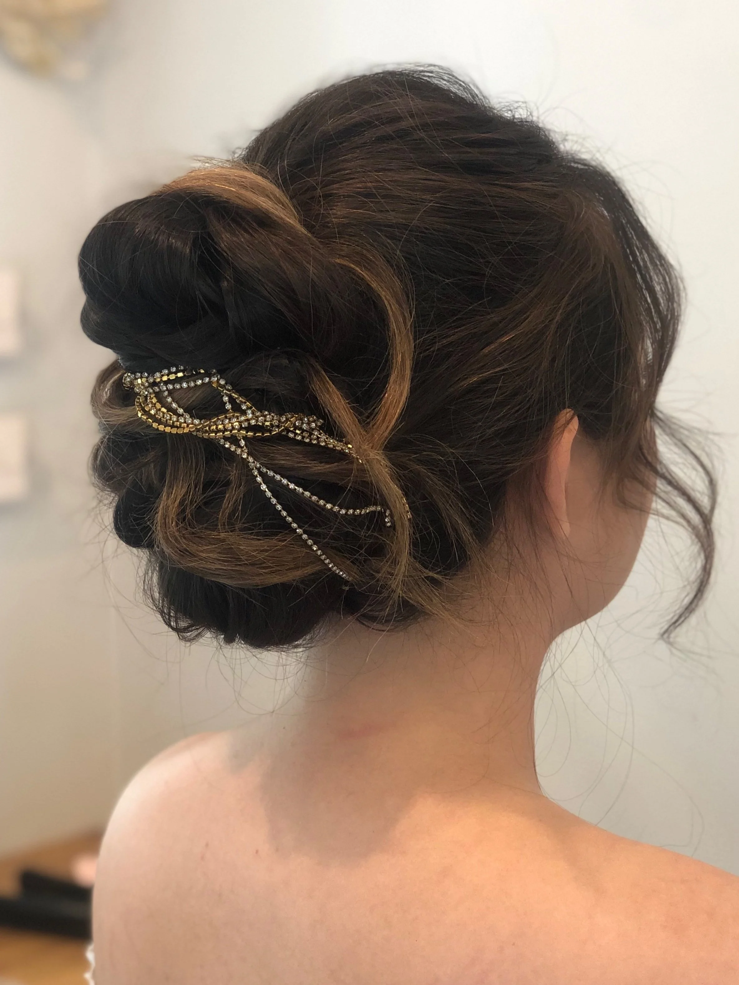 Textured bridal updo for Maryland bride with with decorative gold and rhinestone hair accessory on dark brown hair by Frederick Md hairstylist
