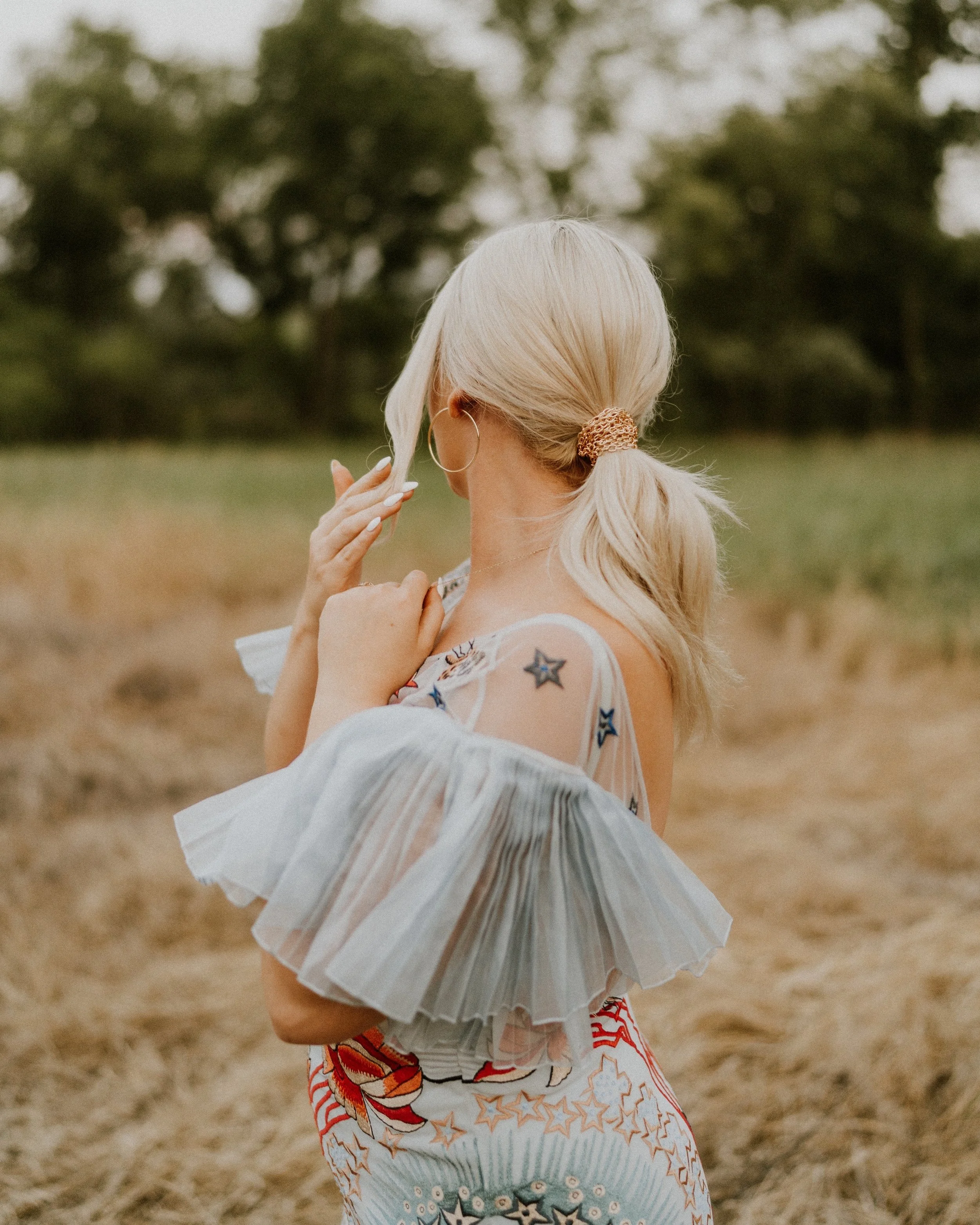 Glowing bridal stylist from Maryland and Pennsylvania featuring soft natural makeup and elegant low pony wrapped with chain