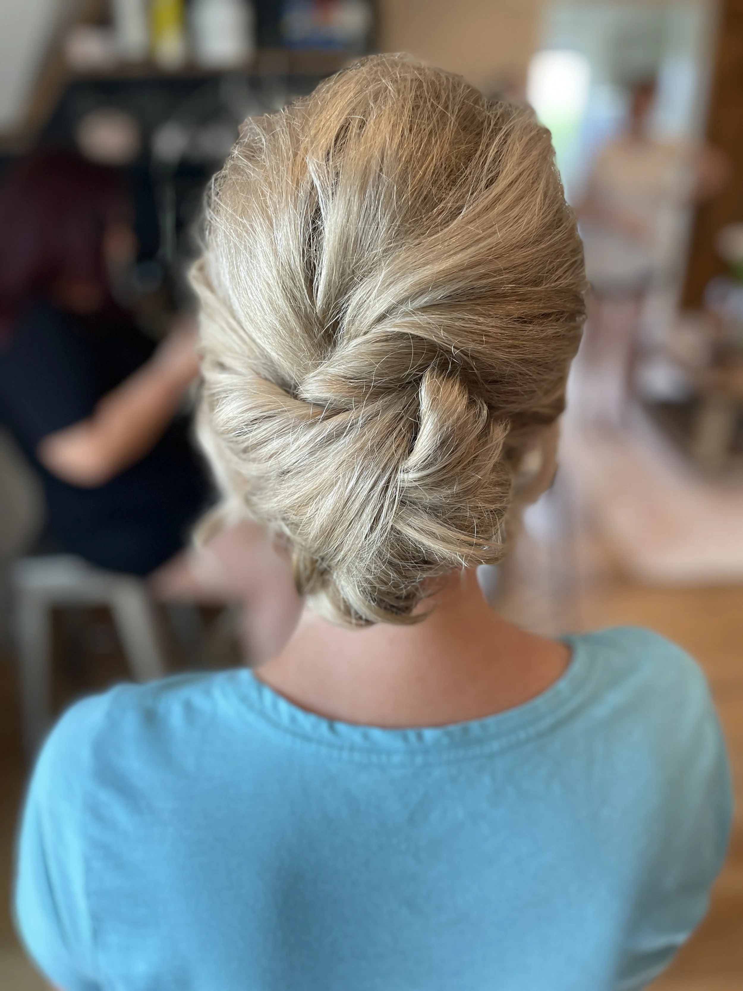 Elegant low bun bridal updo with layered texture in Maryland