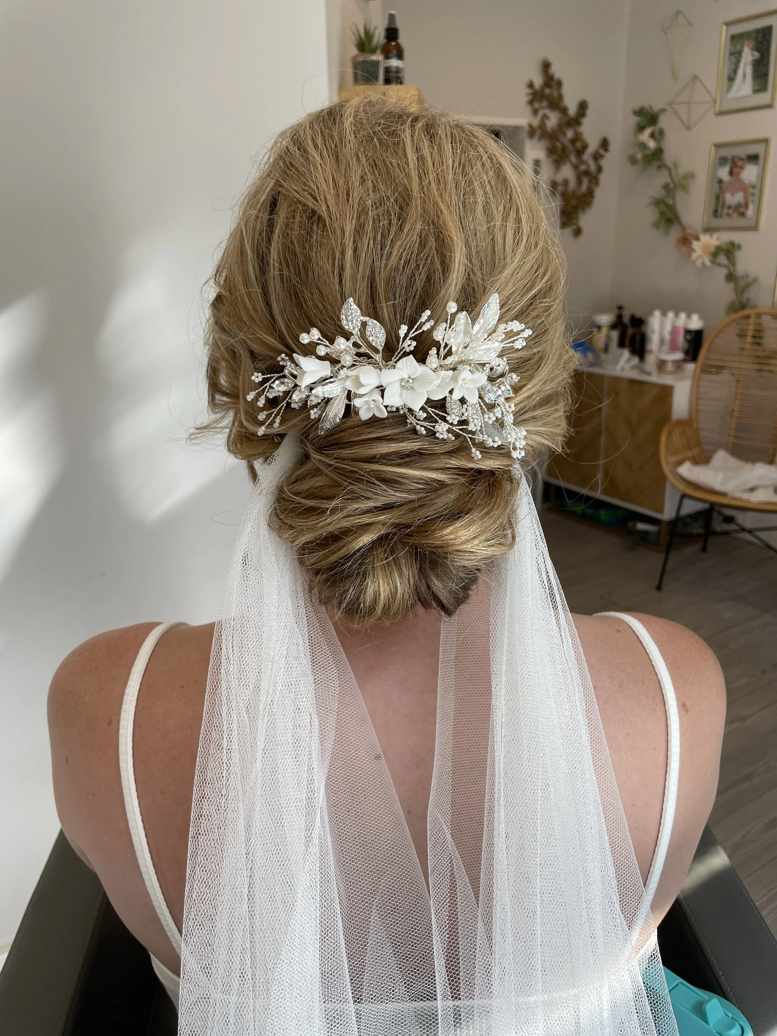 Polished bridal updo with subtle accessory accent styled with bridal veil in Frederick MD