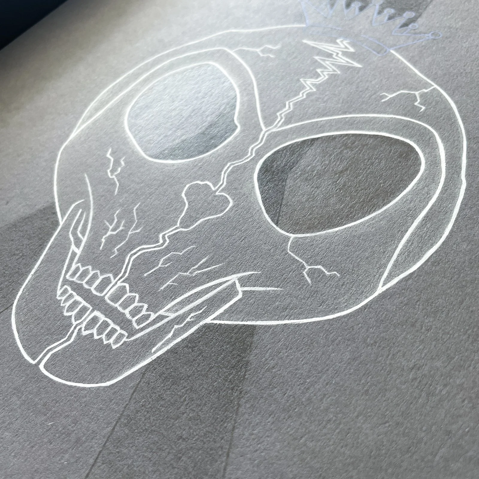 Close-up of Outkast mixed media artwork (graphite, acrylic paint and gloss varnish) of 2 'ATLien' skull halves meeting. Two seperate paths become one in the eye sockets and the Outkast crown rests on top of the formed skull. 