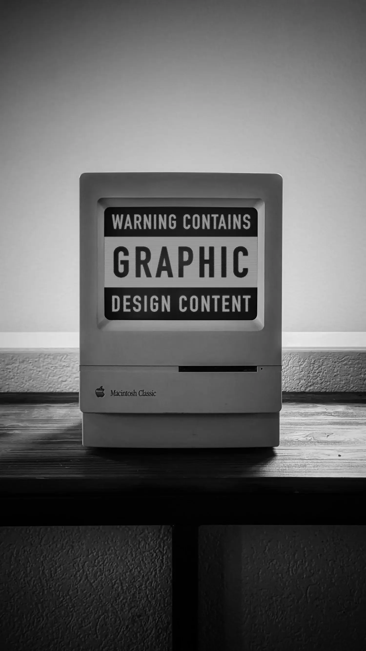 Old Mac with: Warning contains graphic content, on the screen.