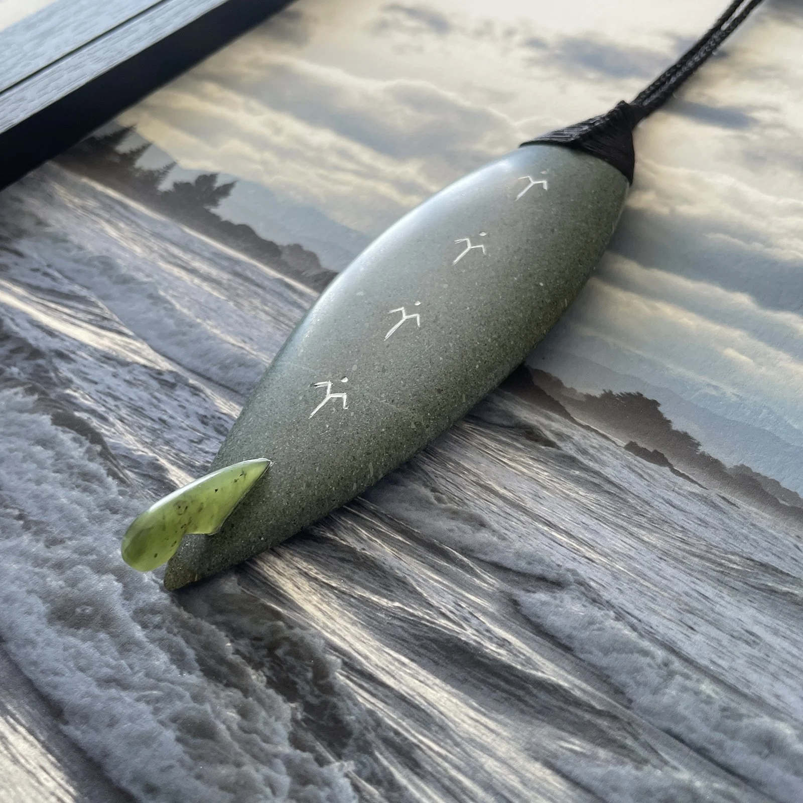 Pounamu surfboard up close over Sumner print.