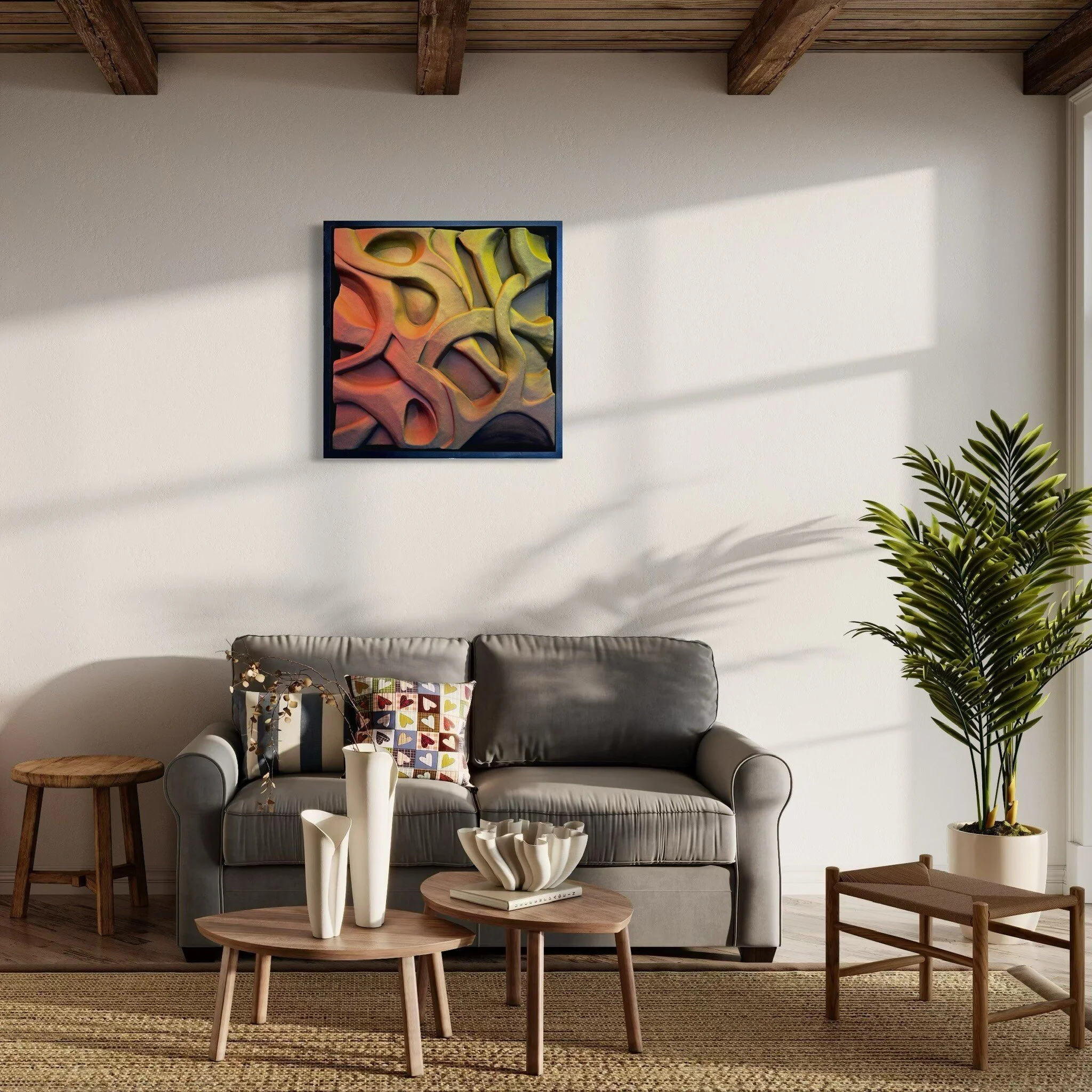 Modern living room with gray sofa, abstract wall art, wooden coffee tables, decorative vases, colorful cushions, and a potted plant.