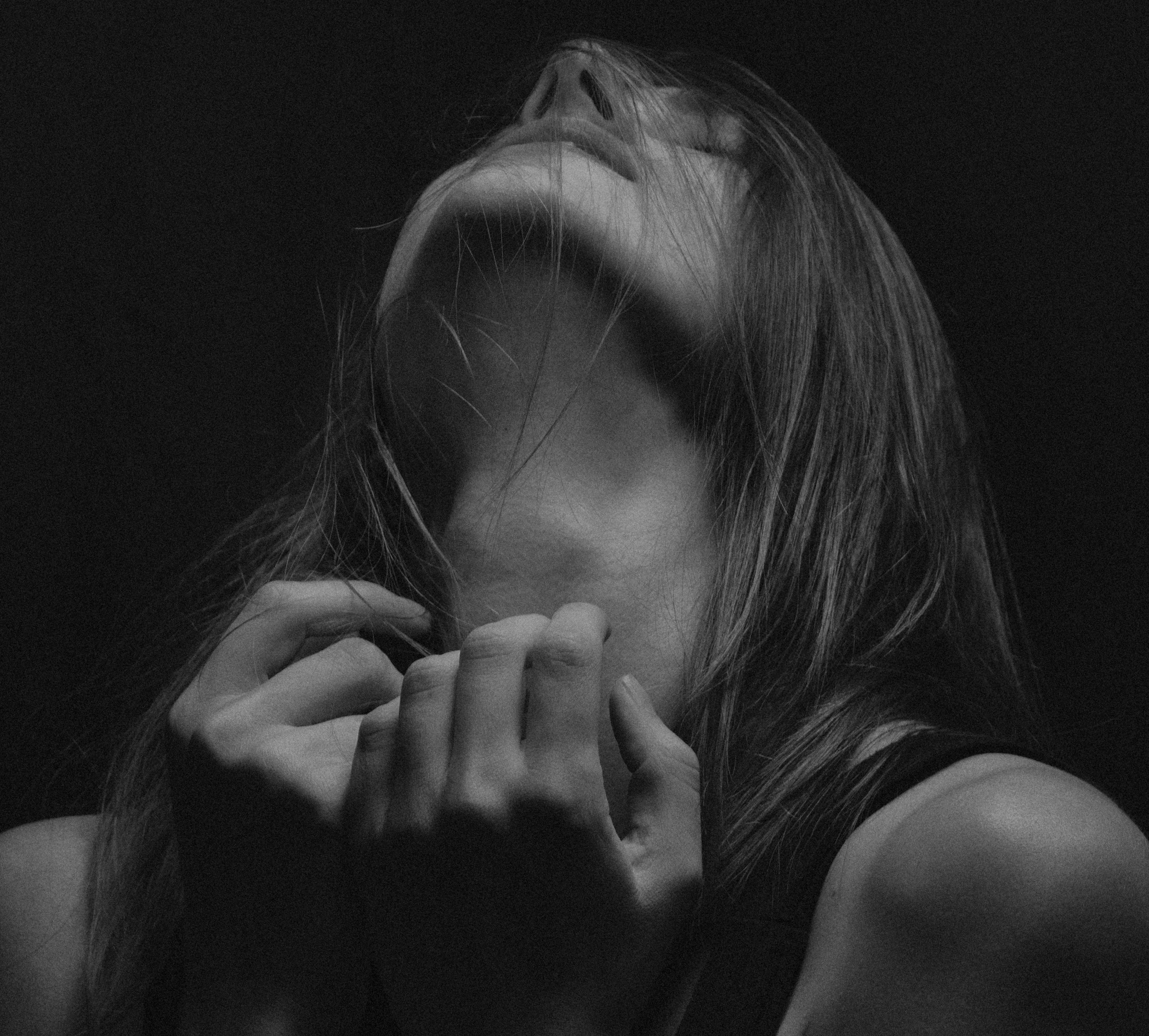 A heart with a sad face, connected to two users with sad expressions, indicating emotional distress or heartbreak.