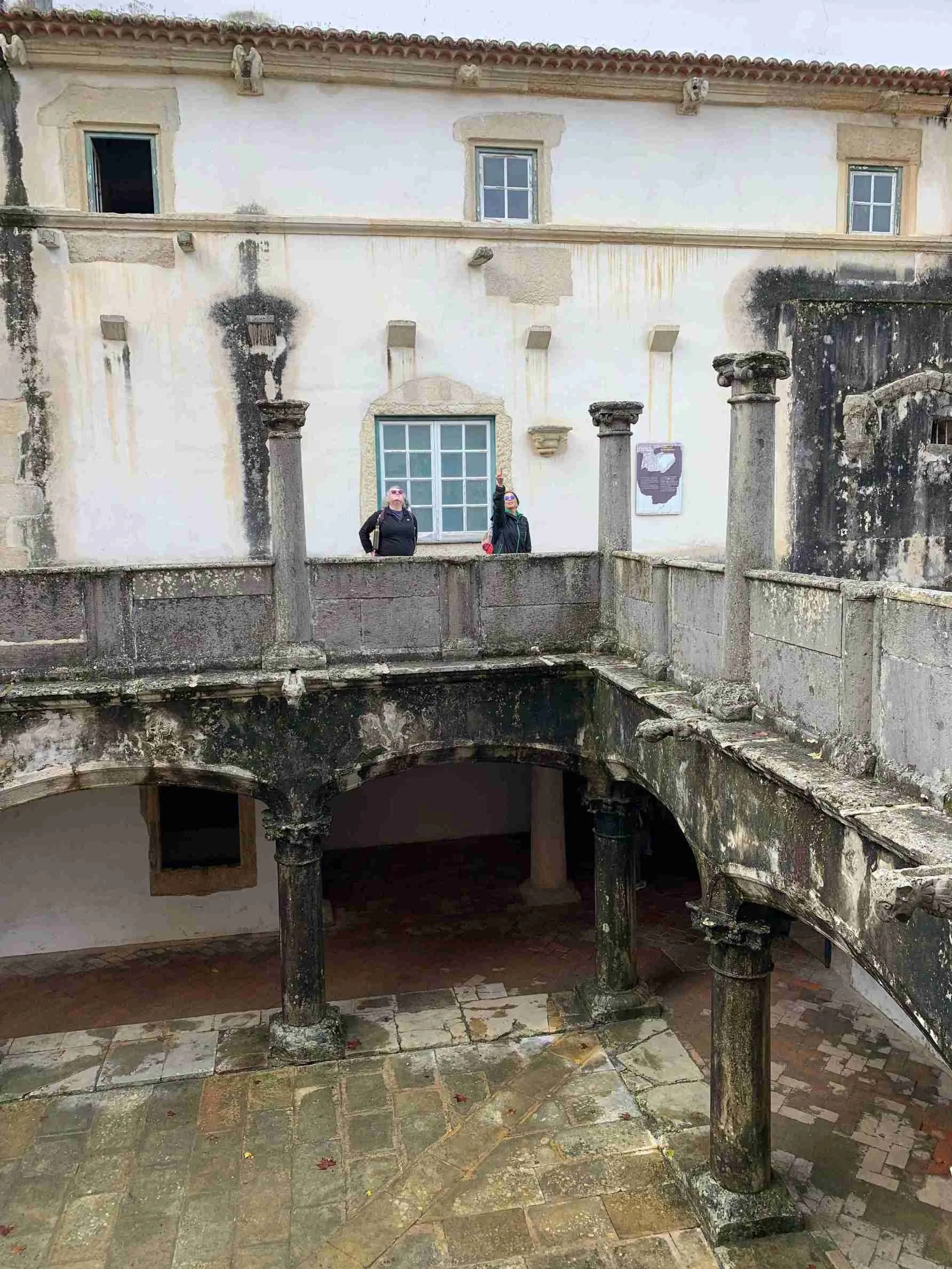 Guests admiring the intricate stone carvings and architectural details of the Convent of Christ in Tomar