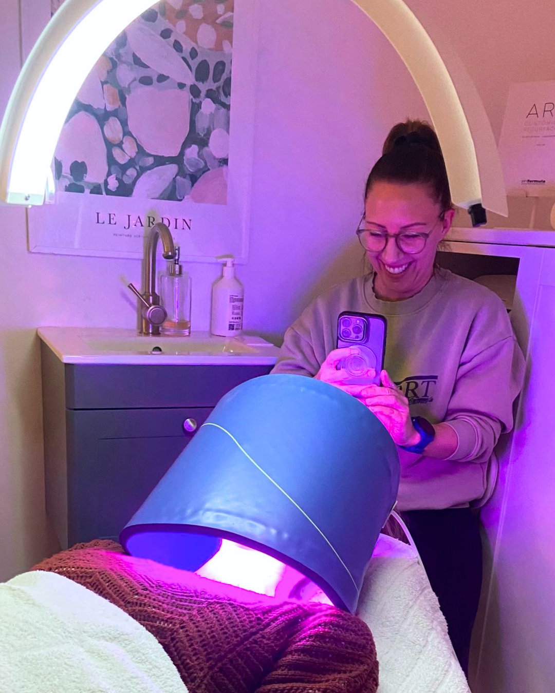 woman taking a photo of a beauty treatment with phone camera