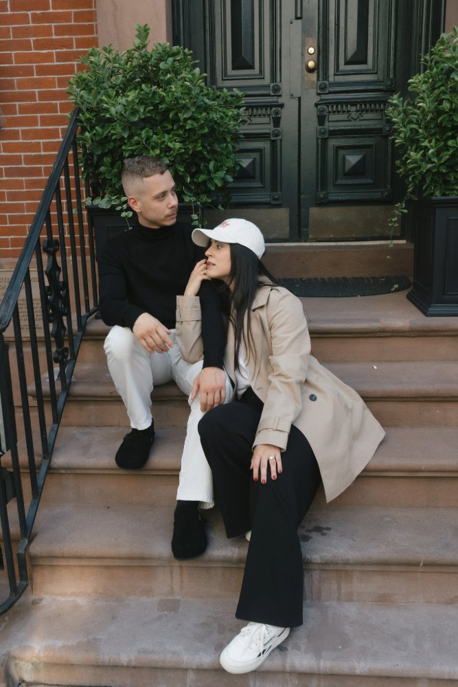 couple sitting on steps posing for picture in new york