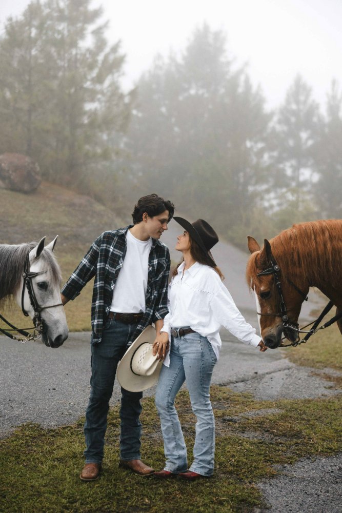couple kissing with horses in outdoor romantic photo session in puerto rico