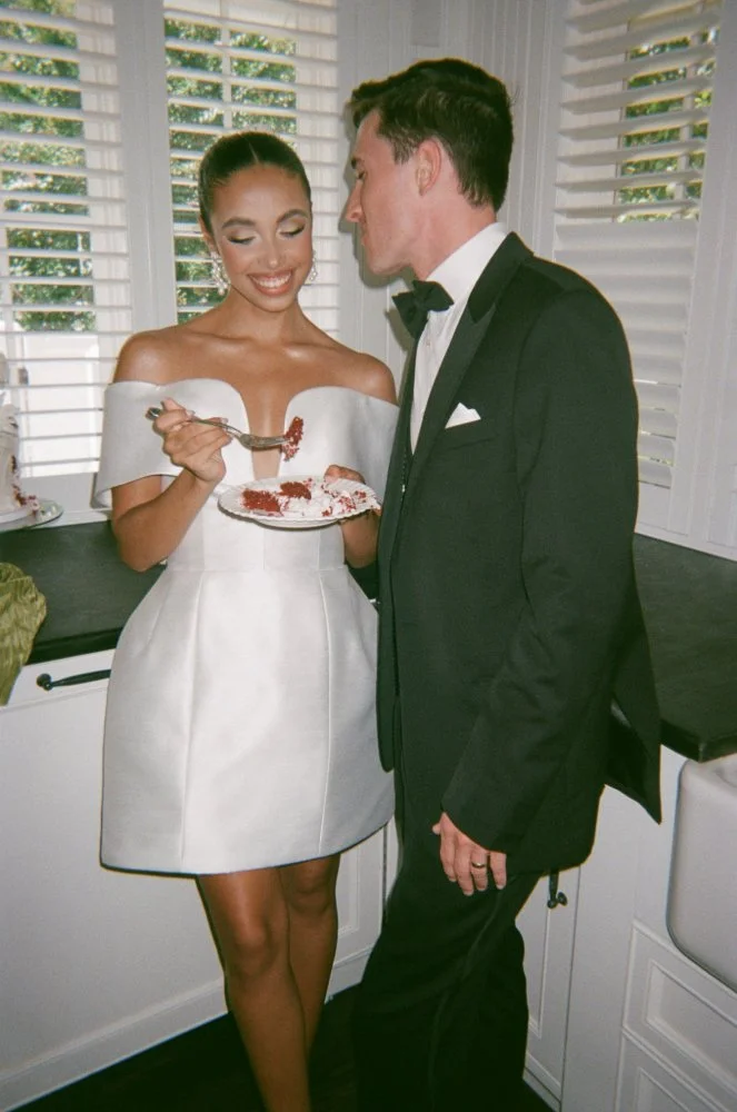 couple eating cake at minimalistic couture styled wedding shoot