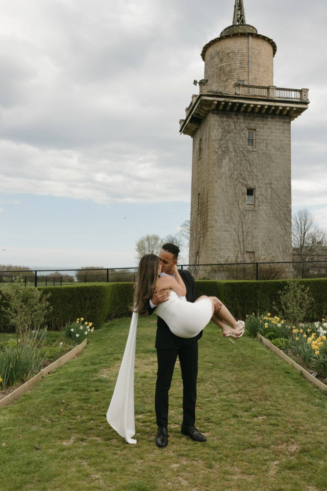 couple kissing during engagement session in old garden