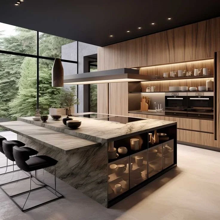 Modern kitchen with large windows, marble island, black bar stools, wooden cabinetry, and open shelves with dishes.