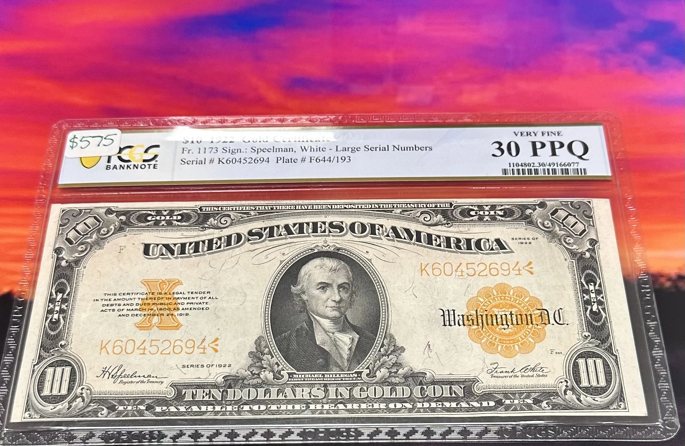 A ten dollar U.S. gold certificate featuring a portrait of Alexander Hamilton, encased in a plastic holder labeled with green and white text indicating it as a very fine grade 30 PPQ, with a handwritten price of $575 on the top left corner.