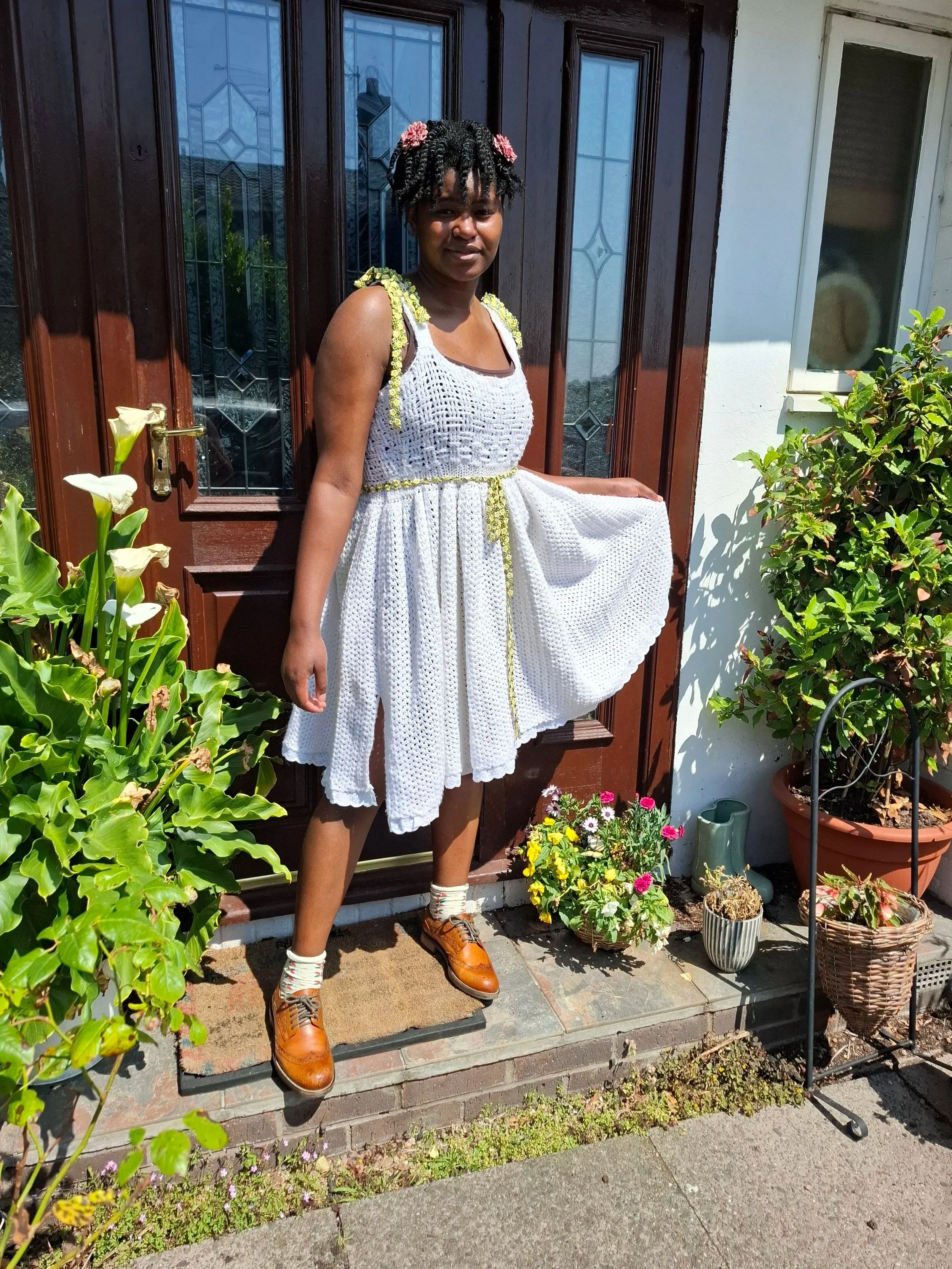 a girl wearing a white crochet dress