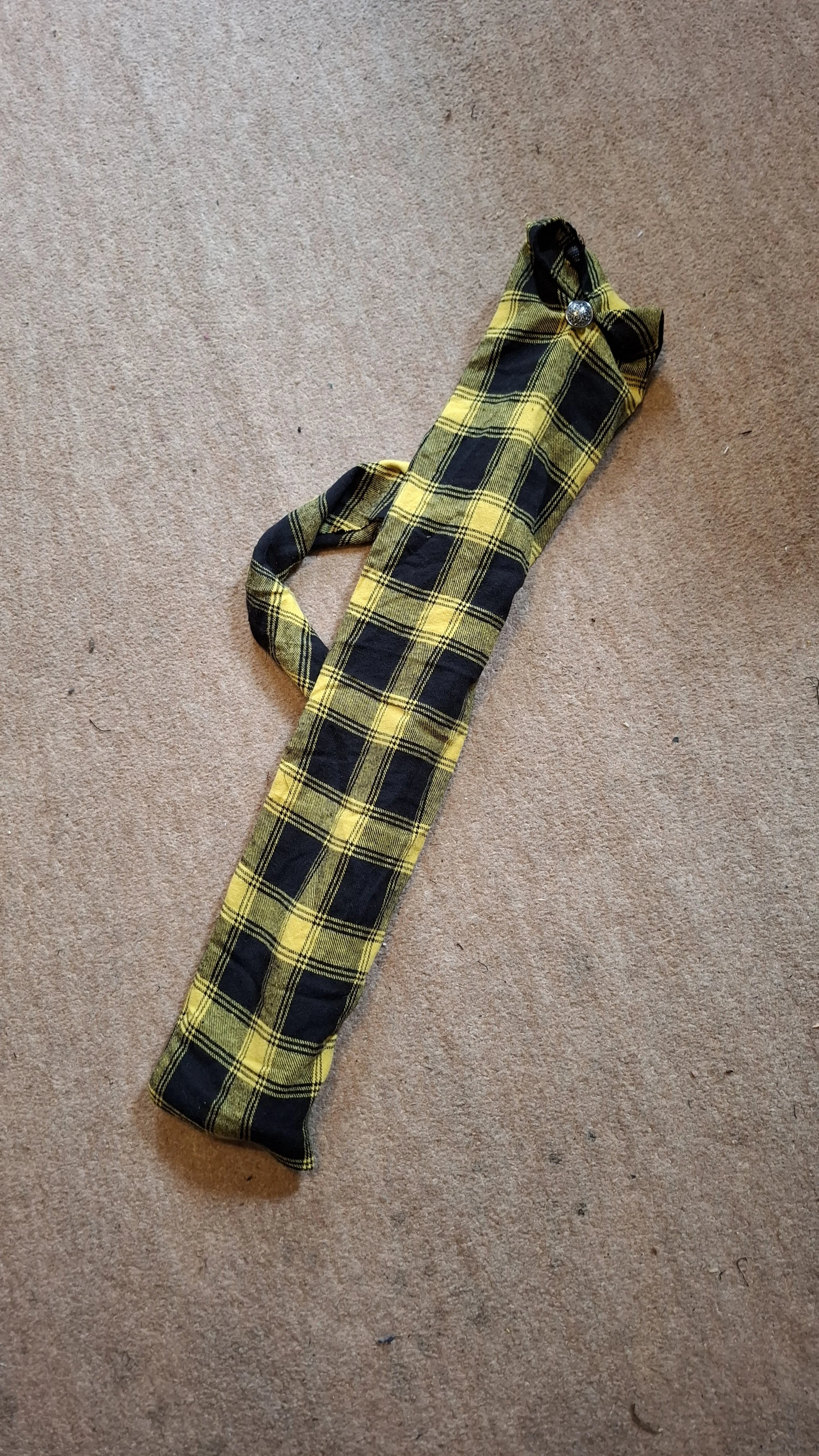 A black and yellow gingham check musical instrument bag