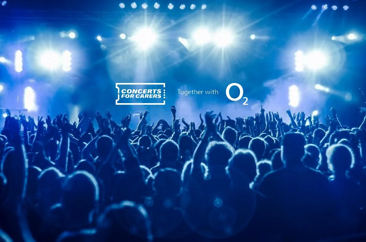A large crowd at a concert with bright stage lights. Overlay text says 'Concerts for Carers' and 'Together with O2'.
