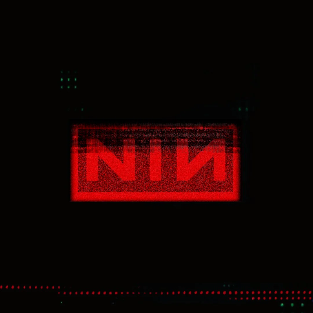 Red digital sign with the word "EXIT" written backwards, illuminated in a dark environment.