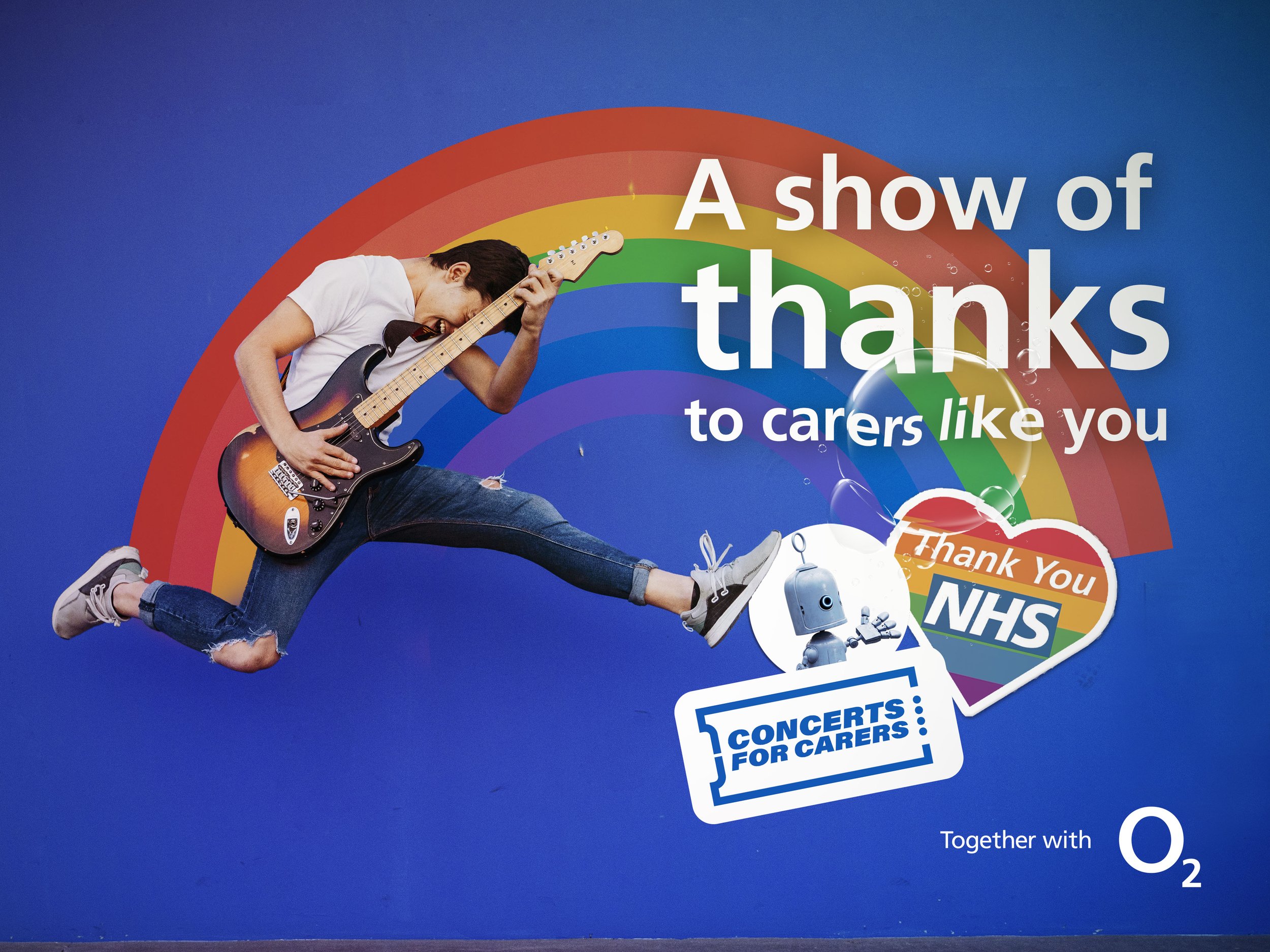 A young man playing an electric guitar, jumping energetically with a rainbow in the background, alongside messages of thanks to healthcare and essential workers from the NHS, with references to concerts for carers and the O2.