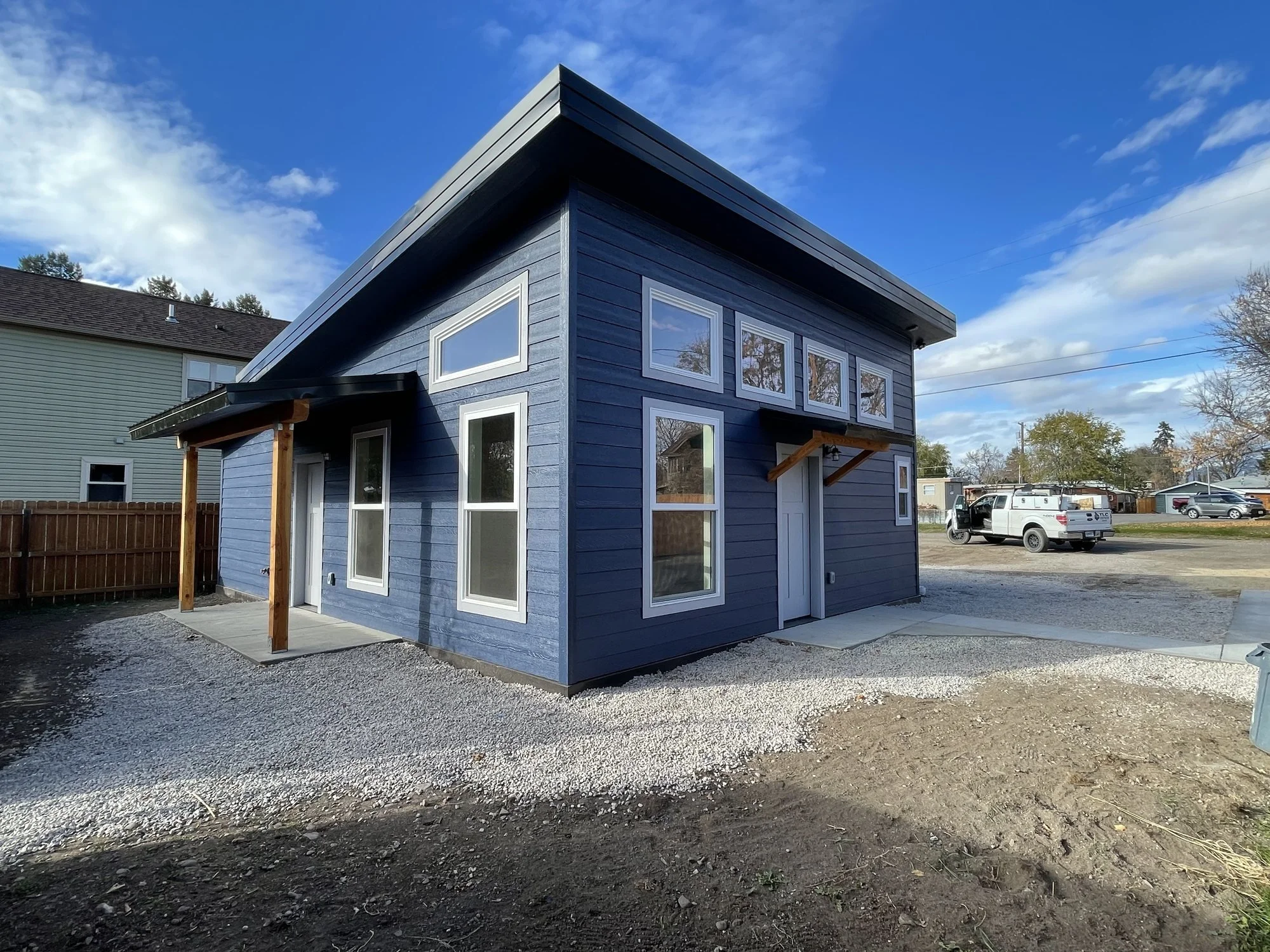 New ADU with navy blue siding and a gravel yard.jpg