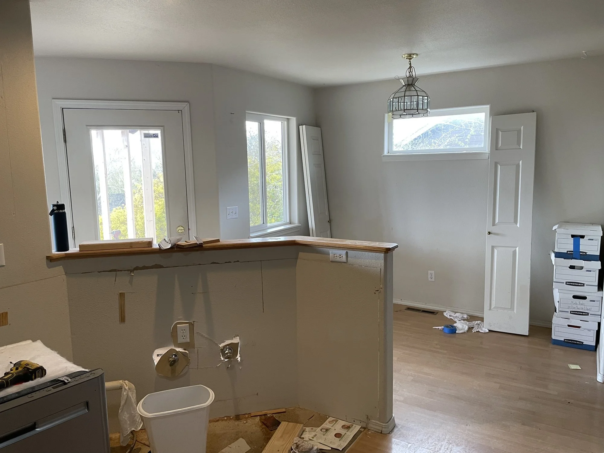 Old kitchen peninsula with the base cabinets pulled out.jpg