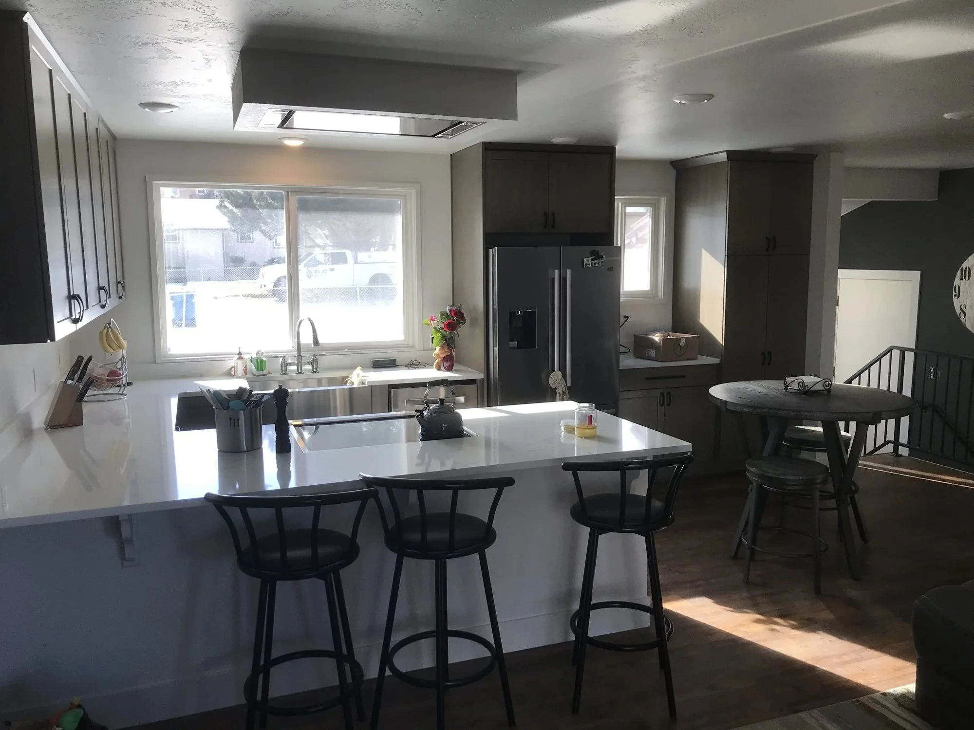 Finished kitchen remodel with island seating and dark wood cabinets.jpg