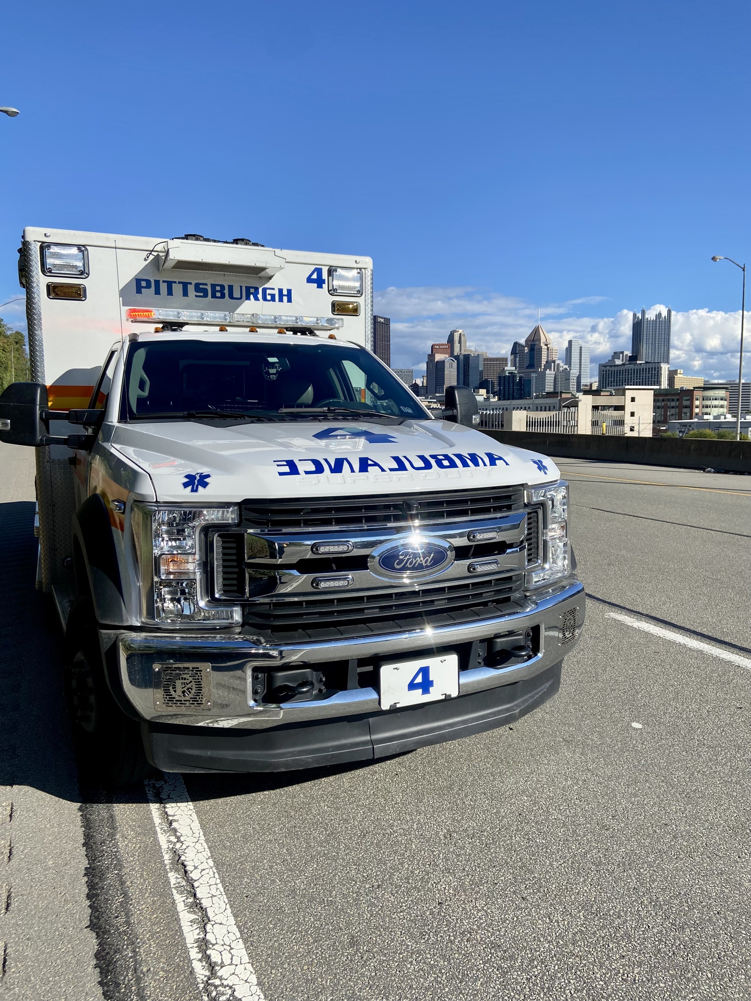 Medic 4 on scene of a call on Ohio River Blvd with the city in the background