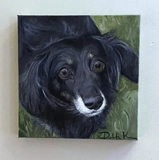 Painting of a black and white dog with brown eyes, looking directly at the camera.